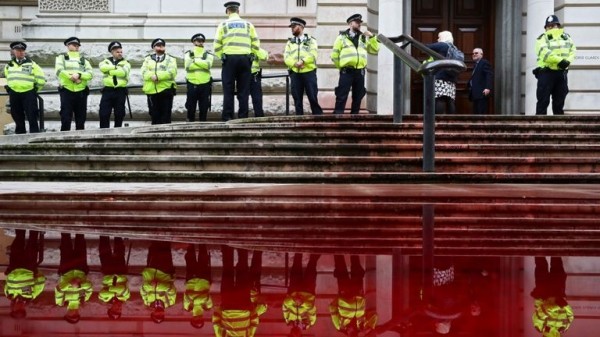
                              Extinction Rebellion protesters use fire engine to spray Treasury with fake blood
                      