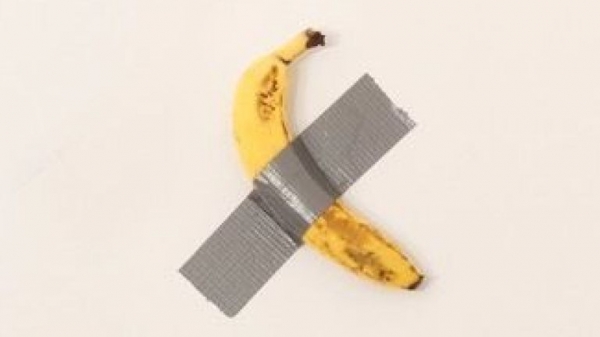 
                              Banana taped to wall which sold for $120k eaten in front of crowd
                      
